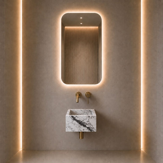 Modern bathroom vanity featuring a rectangular wall-mounted marble sink with a white and gray veined pattern, paired with matte gold faucets and a matching illuminated backlit mirror on a textured beige wall.